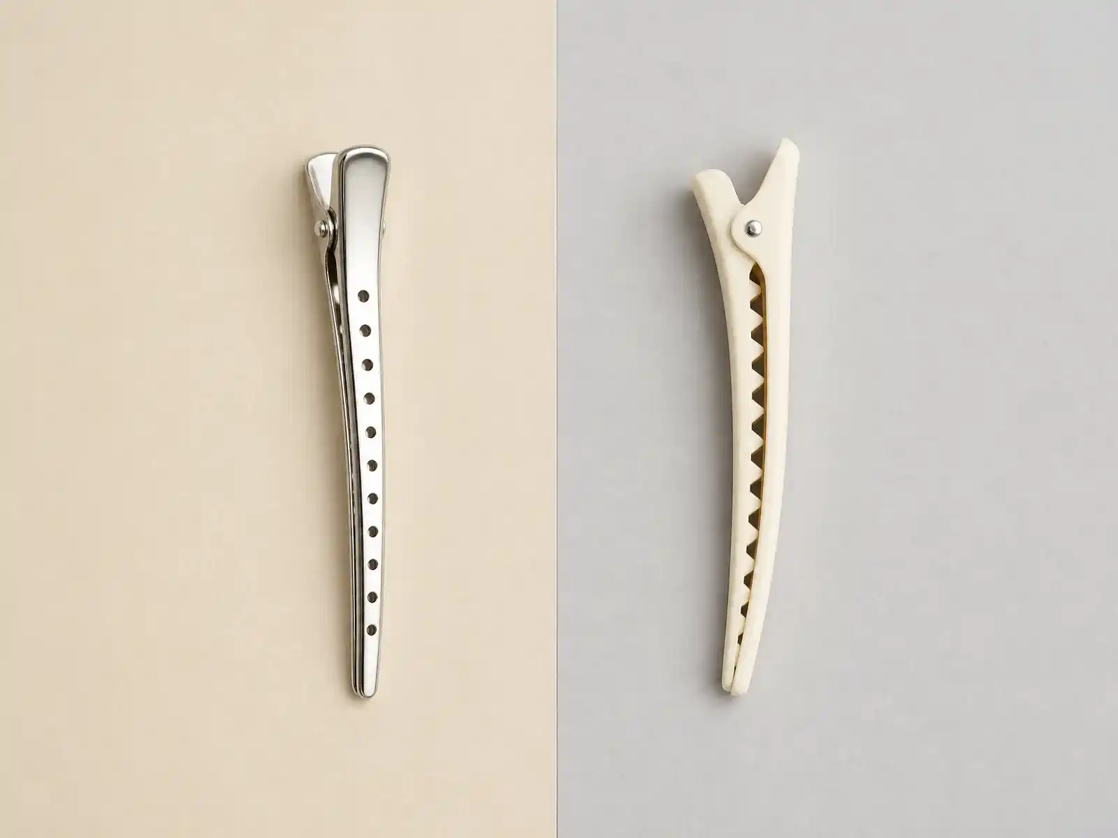 Two sectioning clips side by side on a split cream and grey background: a polished silver metal duck-bill clip with a perforated arm on the left, and a matte cream plastic alligator clip with interlocking teeth on the right